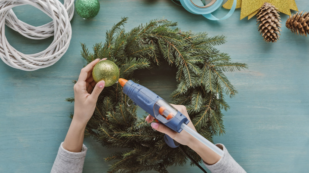 Someone making a holiday wreath.